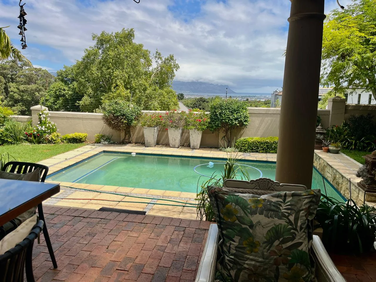 Swimming pool surrounded by a beautiful garden estate